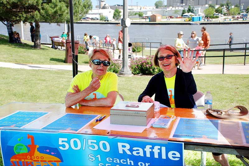 Two volunteers selling raffle tickets