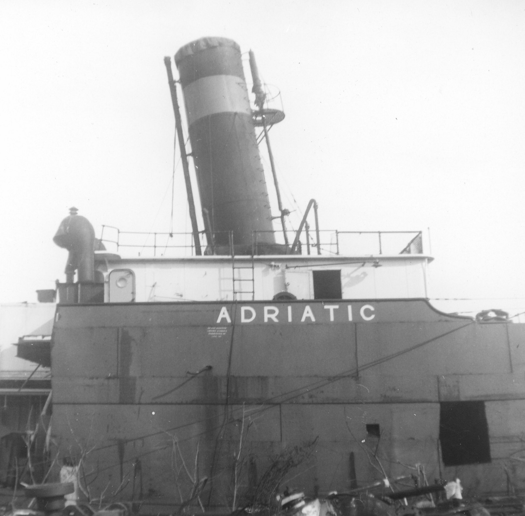 The back end of the self unloader Adriatic. Shows name and smoke stack.